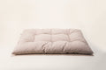 Beige cushion bed on a cream background