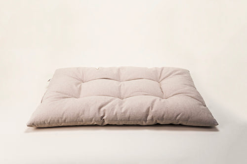 Beige cushion bed on a cream background